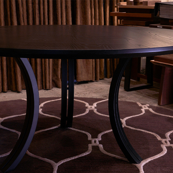 Ebonized Ash Round Dining Table with Reverse Knife Edge and Three Double Arc Steel Legs
