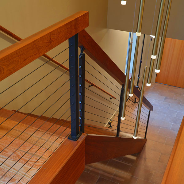 Custom Cable Railing System Being Installed with Substantial Solid Wood Mitered Handrails