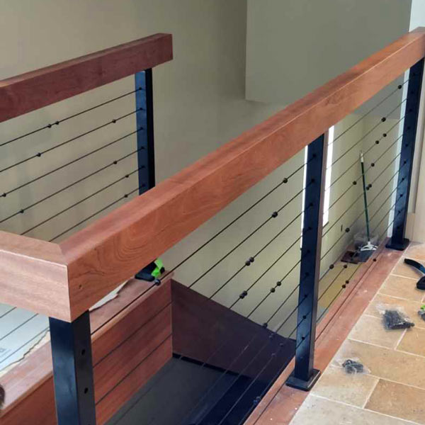 Custom Cable Railing System Being Installed with Sustantial Solid Wood Mitered Handrails