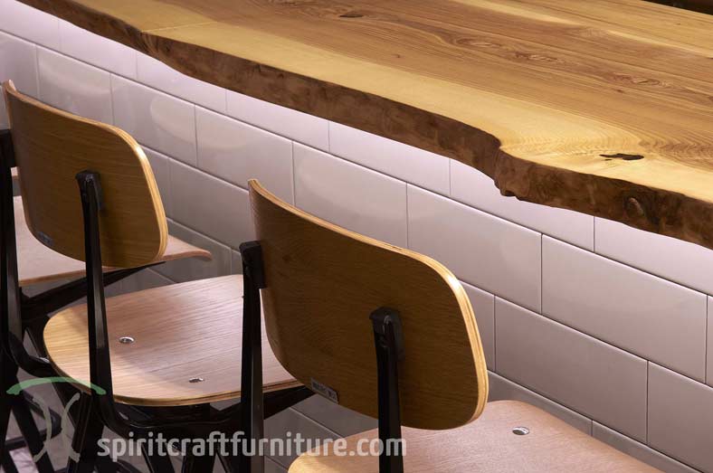 Close up of Ash live edge slab bartop at Chicago area restaurant and brew pub from spiritcraft furniture, dundee, il.