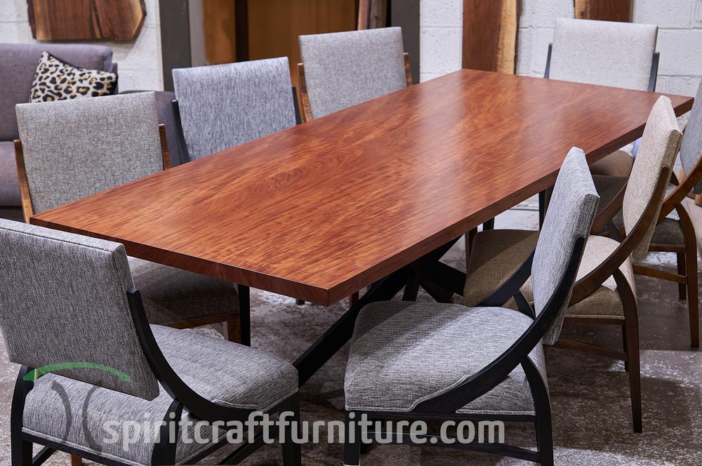 Bubinga-wide plank dining table with RH Yoder dining chairs at the Spiritcraft Furniture table showroom in Dundee, Illinois.