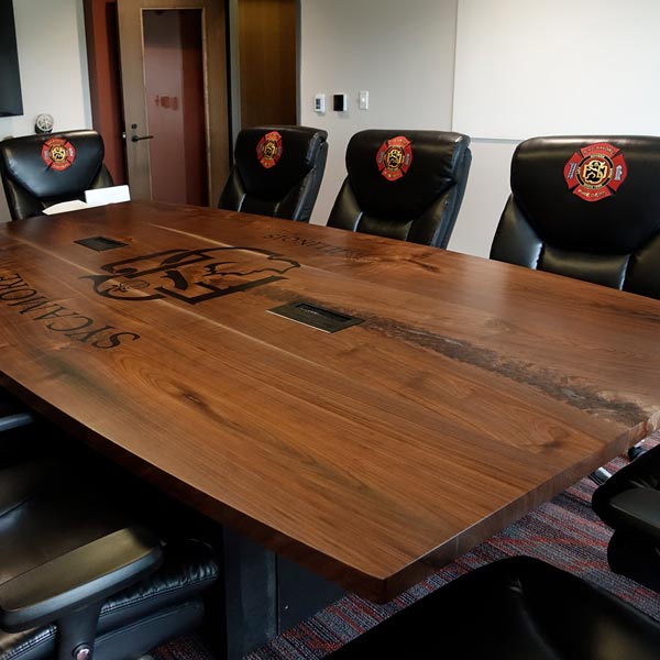 Custom 144" by 72"" Walnut Boat Shaped Conference Table with Filled Inlay Logo for Suburban Chicago Fire Department