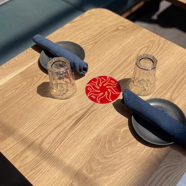 Custom two-top White Oak restaurant tables with ceramic inlays for Chicago Hotel restaurant