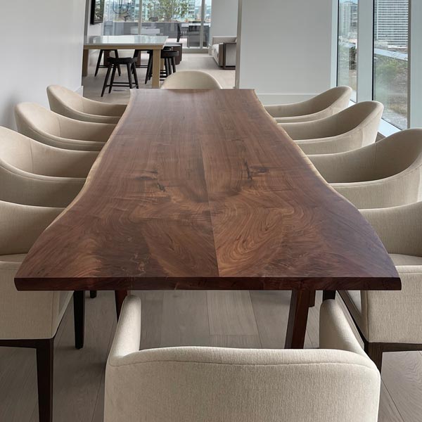 Twelve foot long walnut natural edge dining table for Chicago client