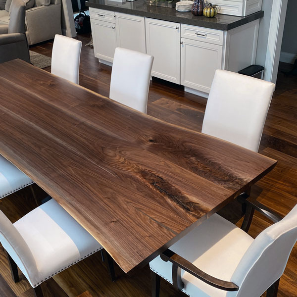 Ten foot long live edge dining table from kiln dried Black Walnut slabs