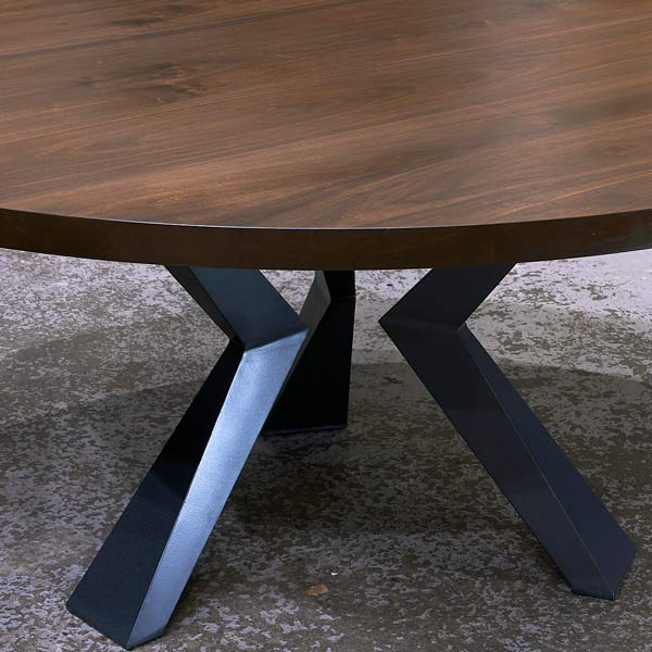 72" Black Walnut Round Dining Table with Geometric Steel Knee Legs in our Furniture Showroom