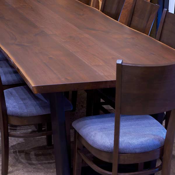144" Black Walnut live edge conference table shown with RH Yoder Somerset side chairs in our showroom