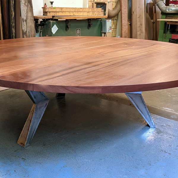 108 inch Round Two Piece Sapele Dining Table Pre-Assembled with Geometric Knee Legs Prior to Shipping - Table Ships in Two Half-Moon Sections.