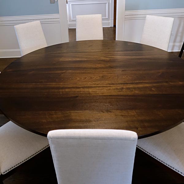80 inch Diameter Round Stained Makore Dining Table with RH Yoder Bradbury Upholstered Side Chairs by Spiritcraft Furniture in East Dundee, Illinois.