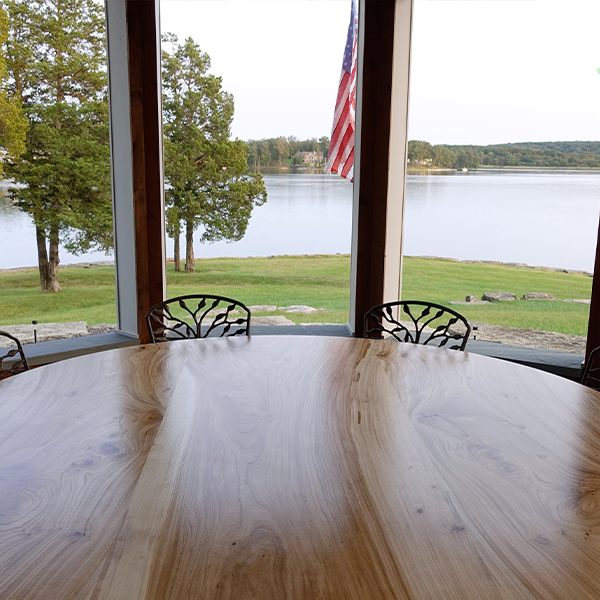 Large 90 inch Solid Elm Round Dining Table in Missouri Lakehouse Sunroom