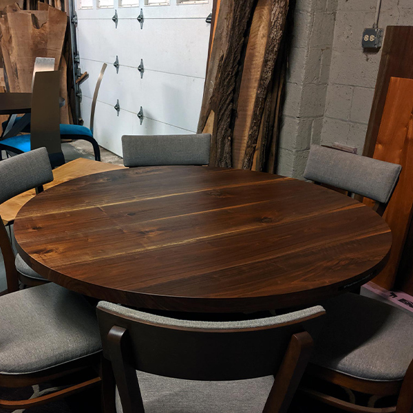 Black Walnut and African Mahogany Custom Round Dining Tables with Custom Bases and RH Yoder Emerson Chairs in Chicago Area Showroom