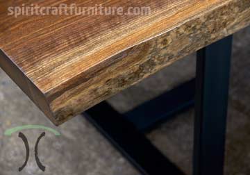 Black Walnut live edge close-up on dining table with steel tri-legs