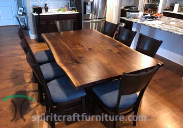 Black Walnut Live Edge Dining Table from Three Slabs of the Same Tree with Custom Made Steel Spider Base and RH Yoder Emerson Side Chairs.