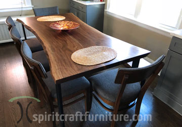 84 inch Live edge dining table in solid Black Walnut live edge slabs on massive powder coated black open U Legs in Chicago area, East Dundee, Illinois