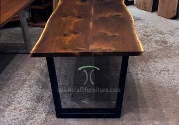 Black Walnut live edge dining table and Bench on thick steel trapezoid legs at Living Edge Furniture Company, East Dundee, IL.