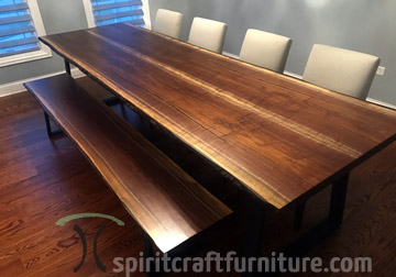 Live edge dining table in solid Black Walnut on trapezoid legs with matching bench