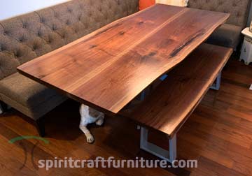 Black Walnut Live Edge Dining Table, Mirror-Image Book Match with Spider Base, Shown with Matching Bench and the Family Dog's Paw.