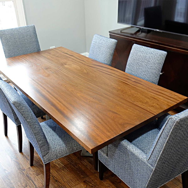 Sapele Mahogany Solid Wood Dining Table with Two Powder Coated Hourglass Bases and Upholstered Chairs